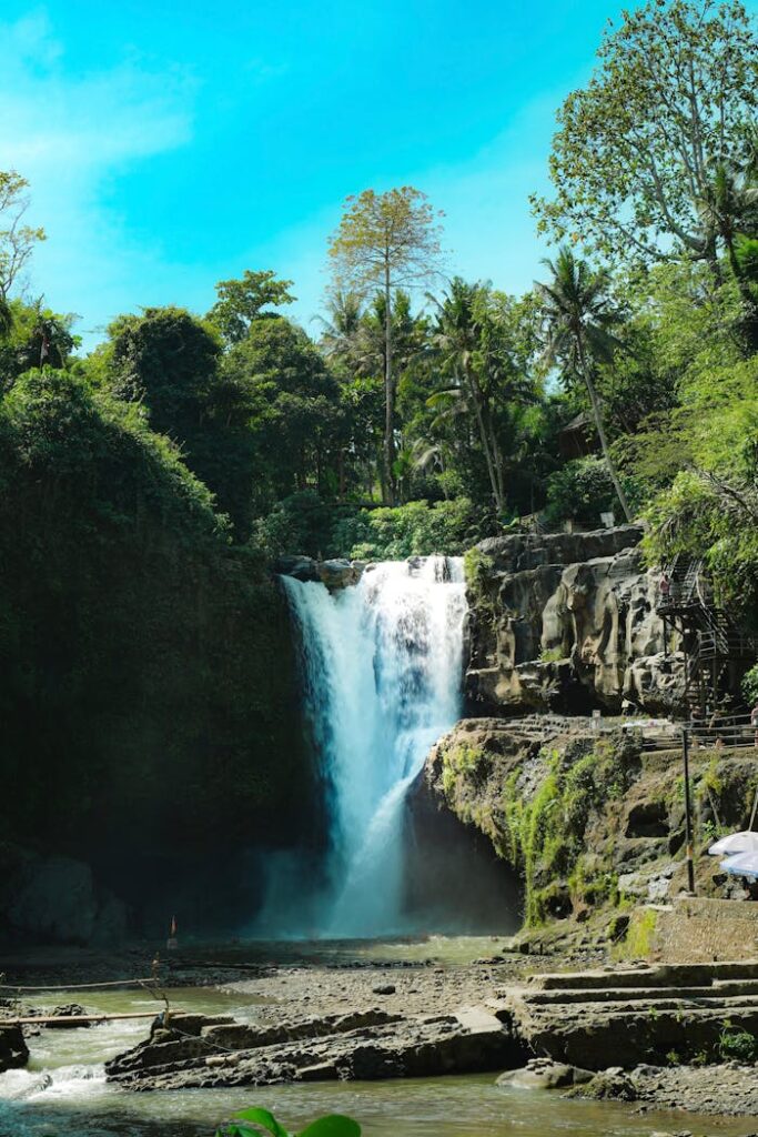 Breathtaking view of Tegenungan Waterfall amidst lush greenery in Bali, Indonesia.