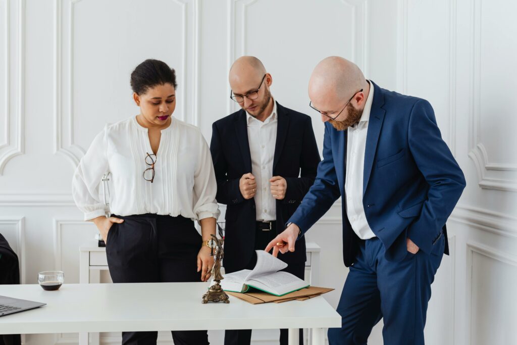 A diverse team of professionals analyzing documents in a modern office setting.